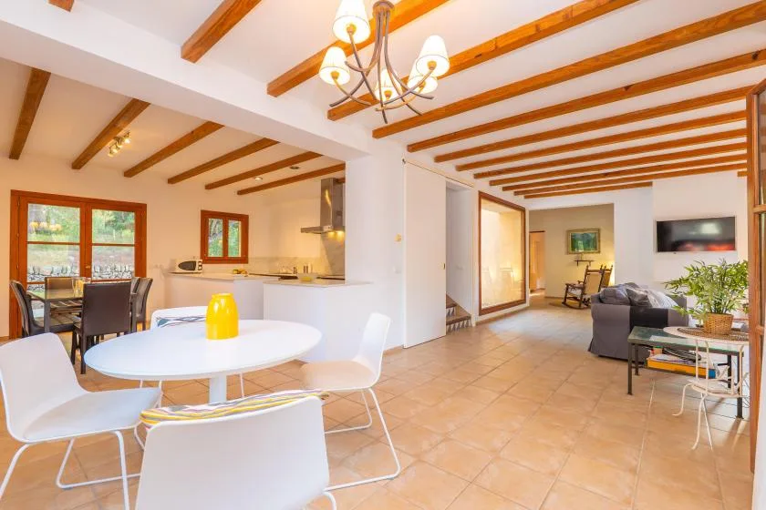 An open-plan living and dining area with a white table and seating.