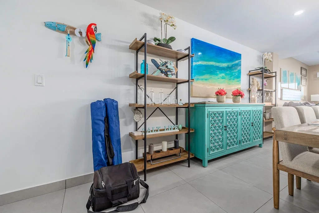 Vibrant coastal charm greets you here with tropical accents, beachy artwork, and open shelving filled with thoughtful touches. Your home base for island adventures awaits.