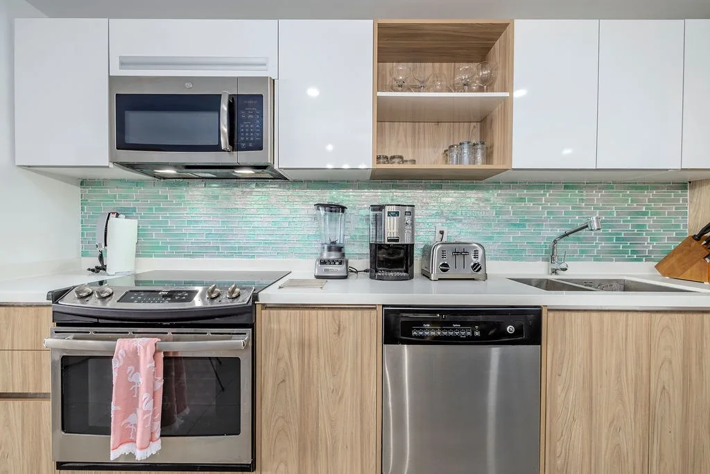 Your home-away-from-home kitchen is fully equipped with stainless steel appliances, a modern glass tile backsplash, and everything you need to prepare delicious meals.