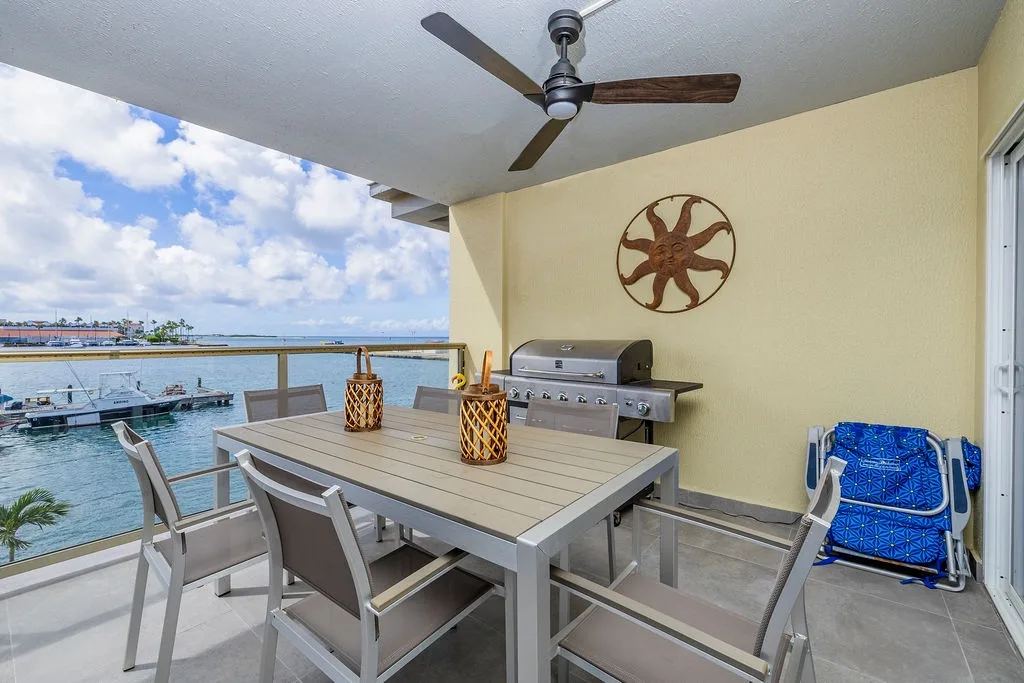 Your private waterfront balcony features dining for six, a grill for fresh catches, and expansive bay views—perfect for morning coffee or sunset dinners.