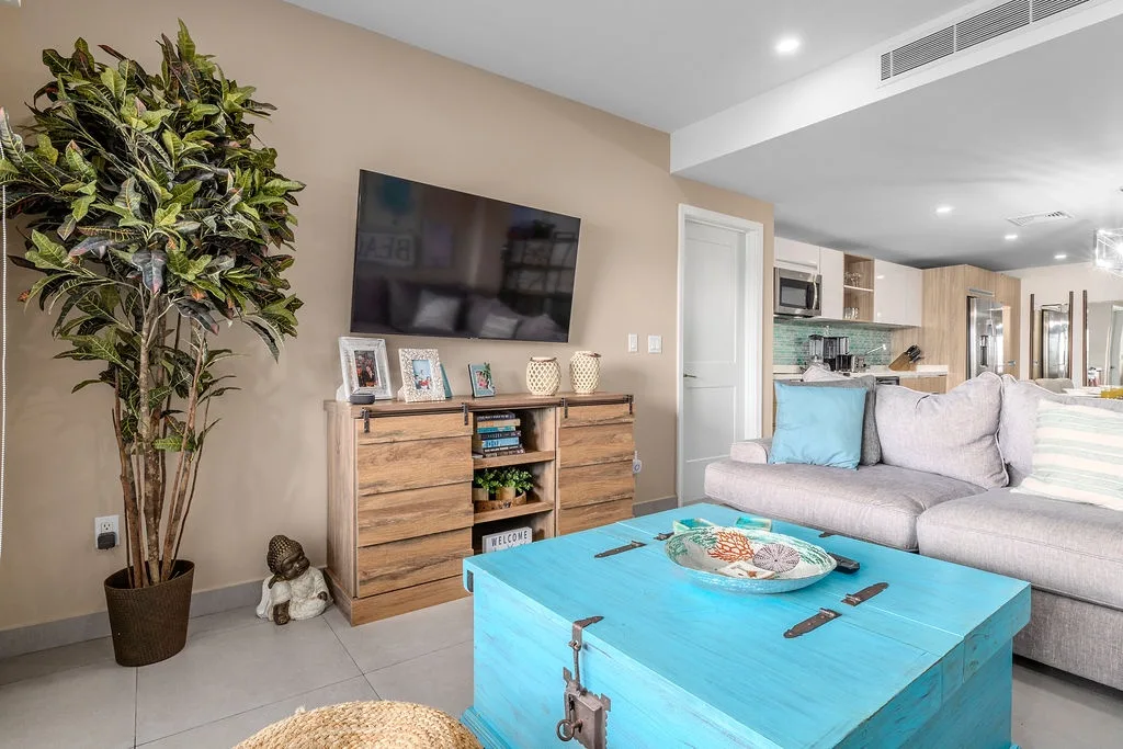 Unwind in your bright, open living space with coastal-inspired touches, plush seating, and modern amenities—perfect for relaxing after a day of adventure.