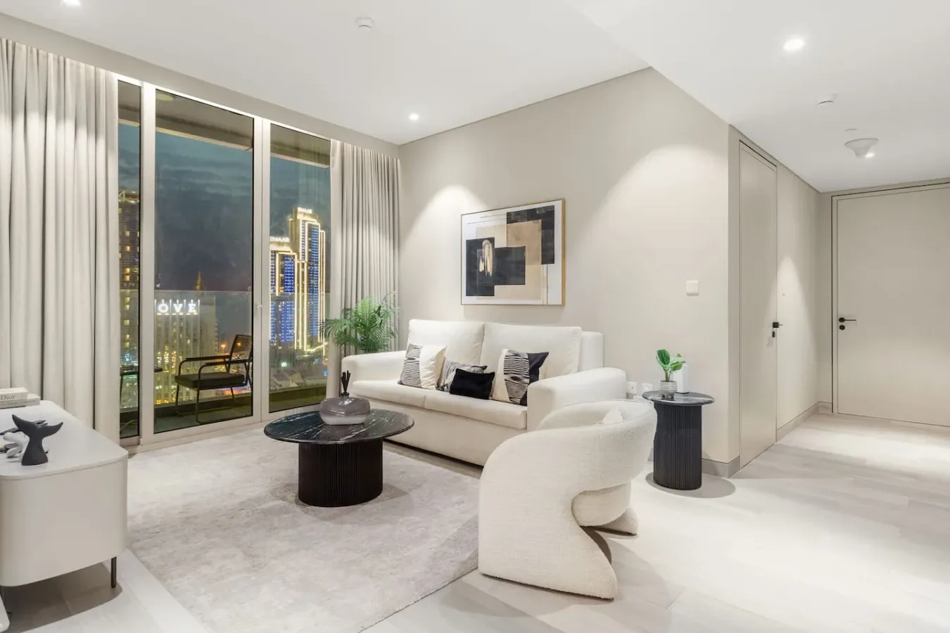 A bright living room with floor-to-ceiling windows and a city view.