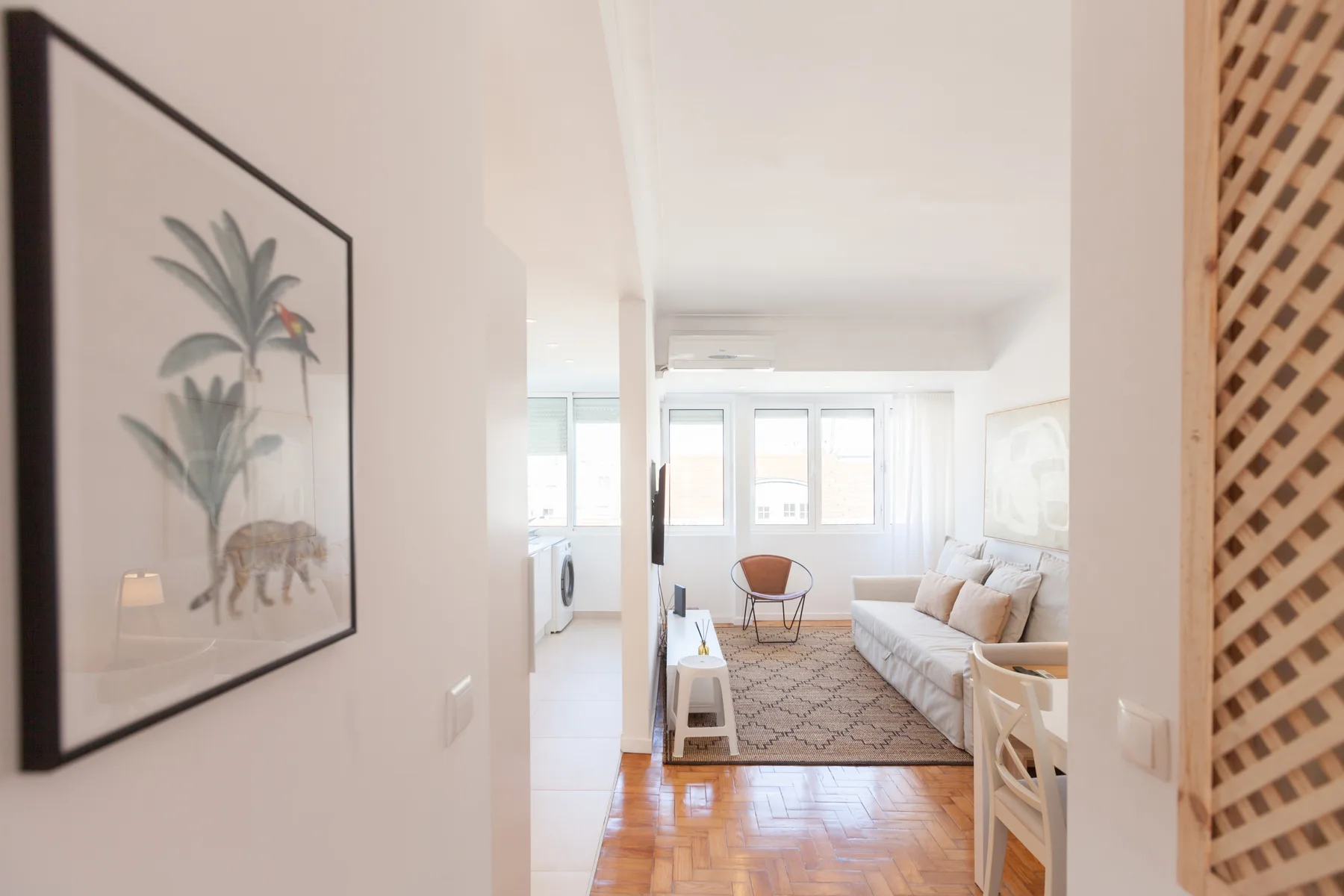 A bright living room with seating and large windows.