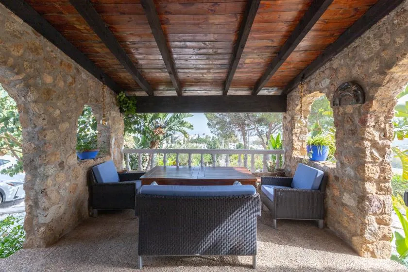 A covered outdoor seating area overlooks tropical greenery.