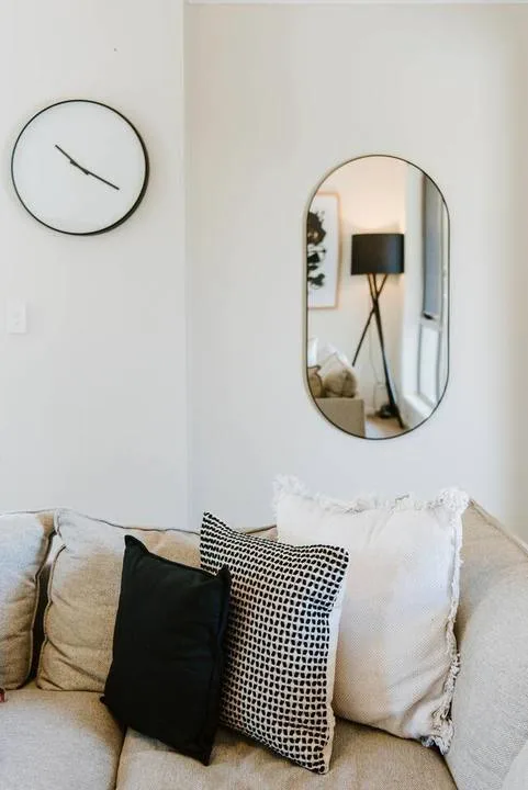 A living room seating area with a light-colored sofa and decorative pillows.