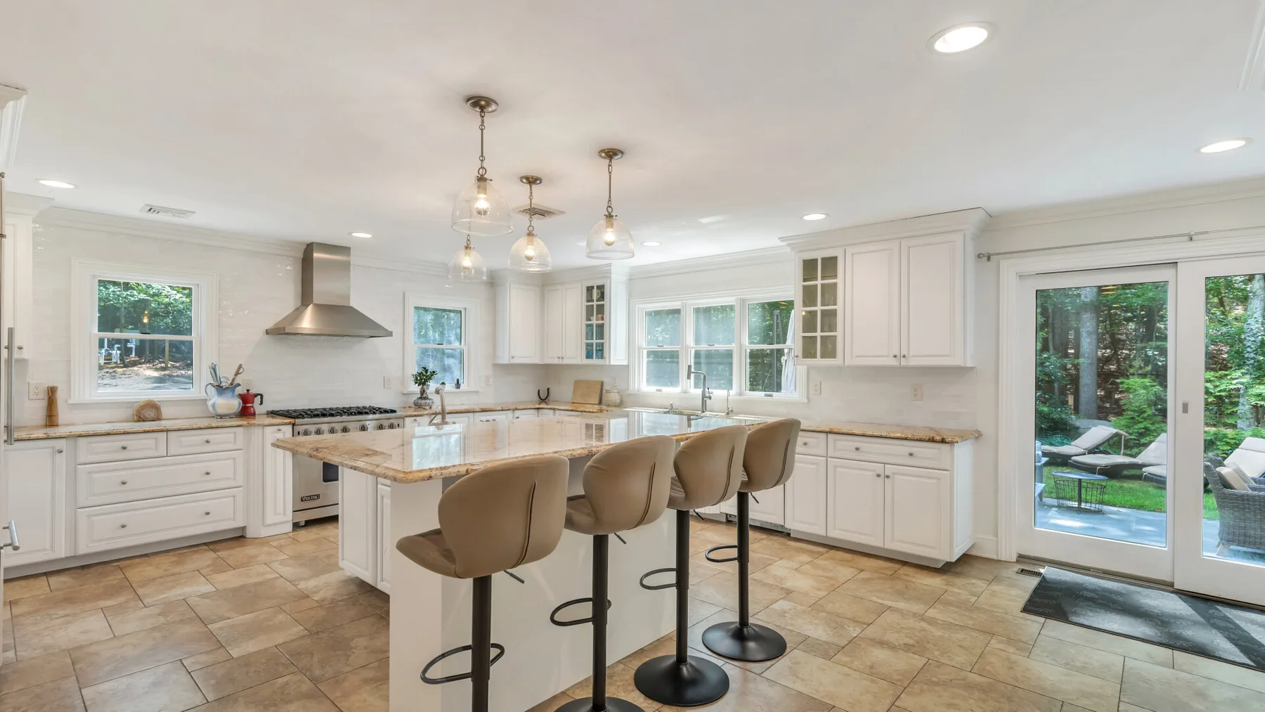 A bright kitchen with a central island and bar seating.