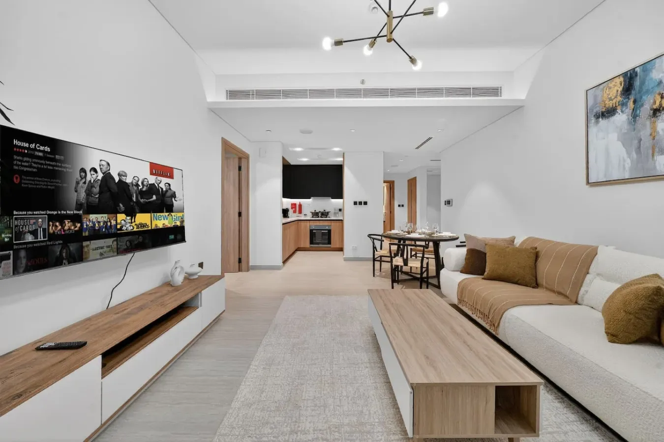 A bright living room with a sofa, coffee table, and dining area.