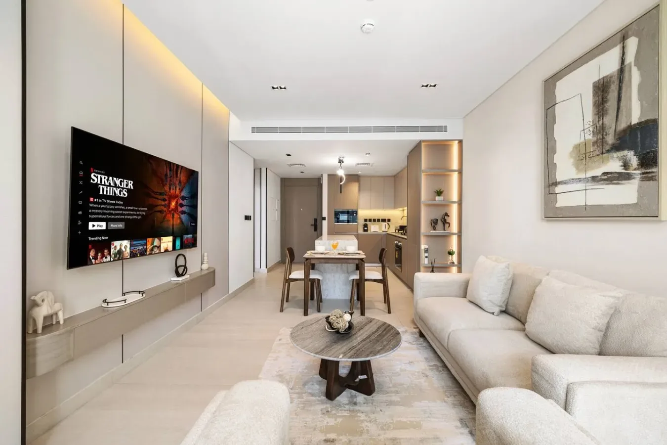 Una sala de estar moderna con mesa de comedor y cocina abierta.