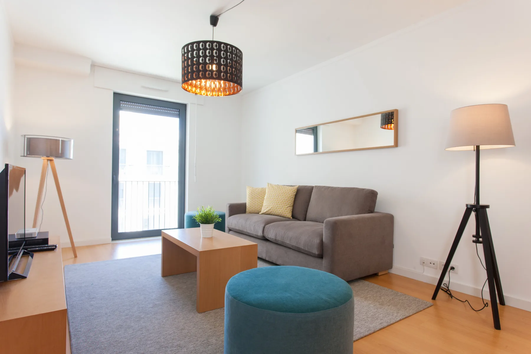 A living room with seating, a coffee table, and a floor lamp.