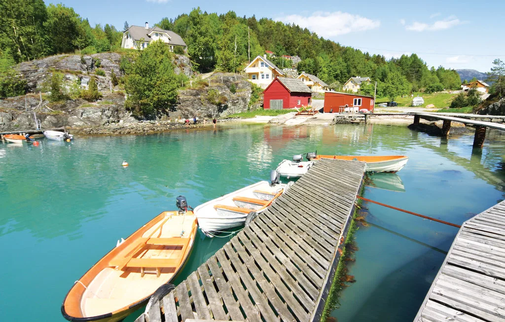 A waterfront marina with small boats moored beside a wooden dock.