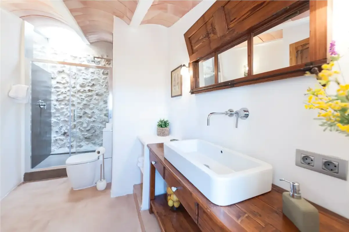 A bathroom with a white bathtub and a glass-enclosed shower.