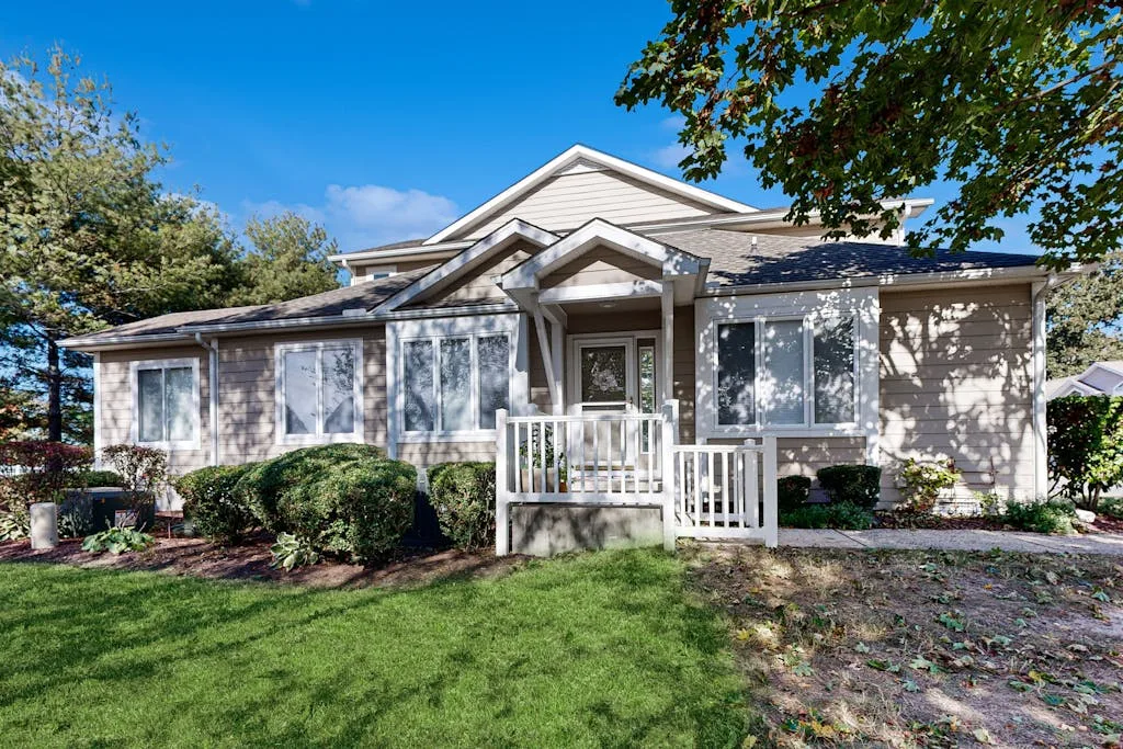 A single-story house with a small porch and lawn in front.