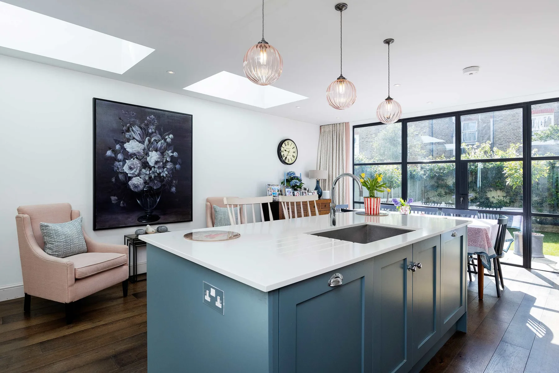 A bright kitchen and dining area with a large island and expansive windows.