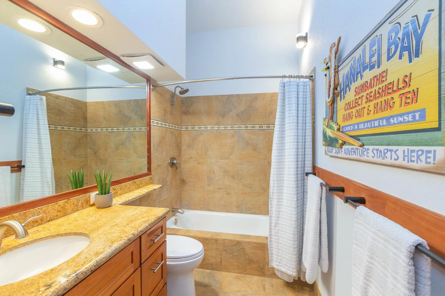A bathroom with a sink, bathtub, and shower curtain.