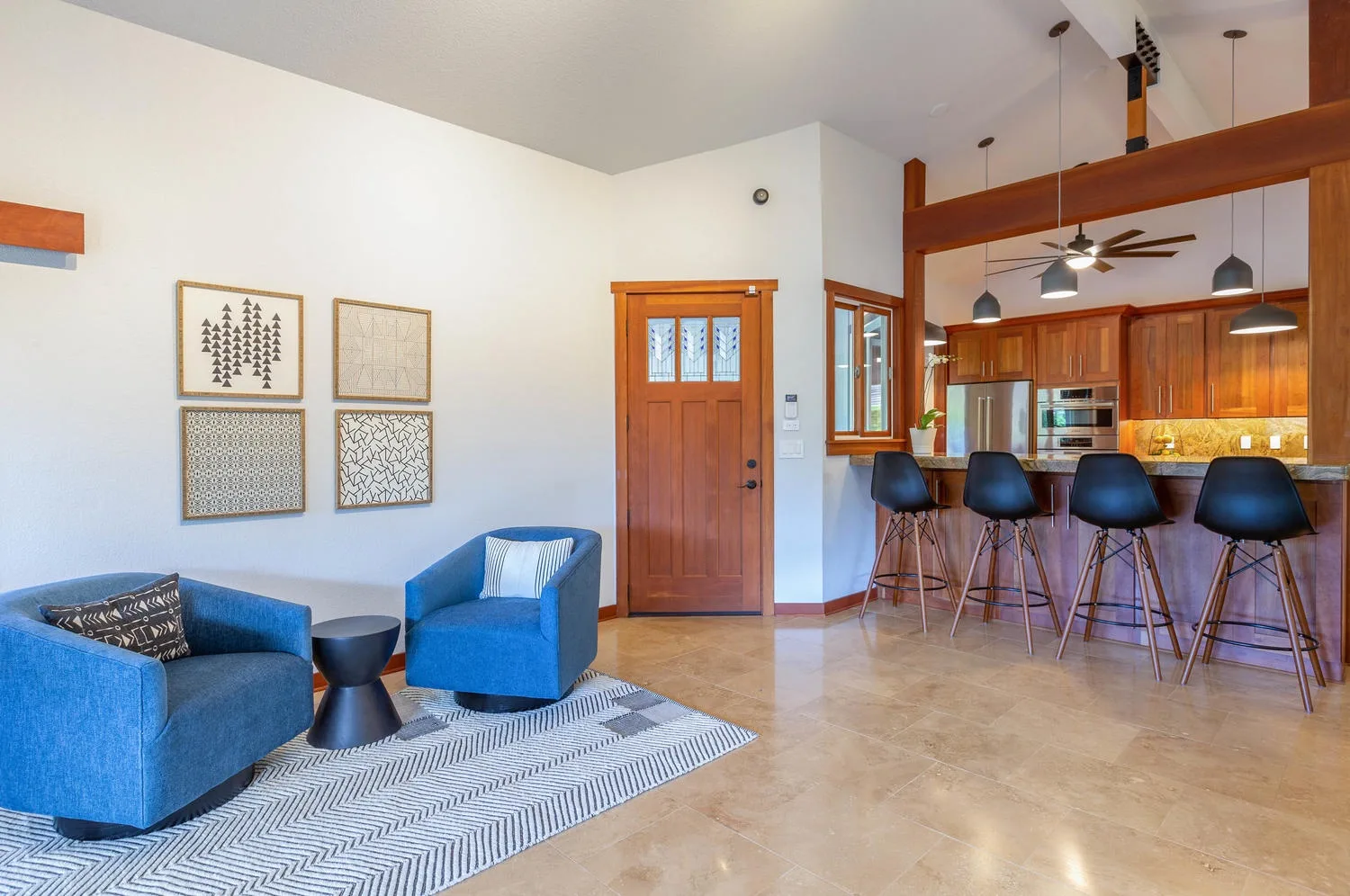 A living room opens onto a kitchen with a counter and bar seating.