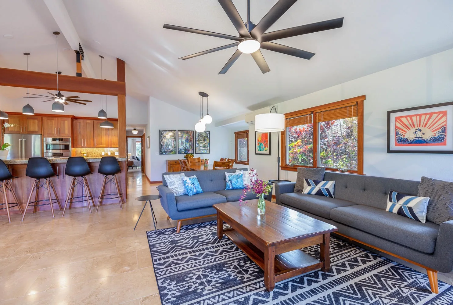 An open living room with a gray sectional and a wooden coffee table.