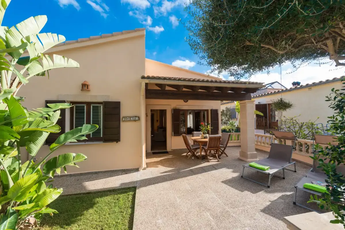 A house patio with outdoor seating and a shaded pergola.