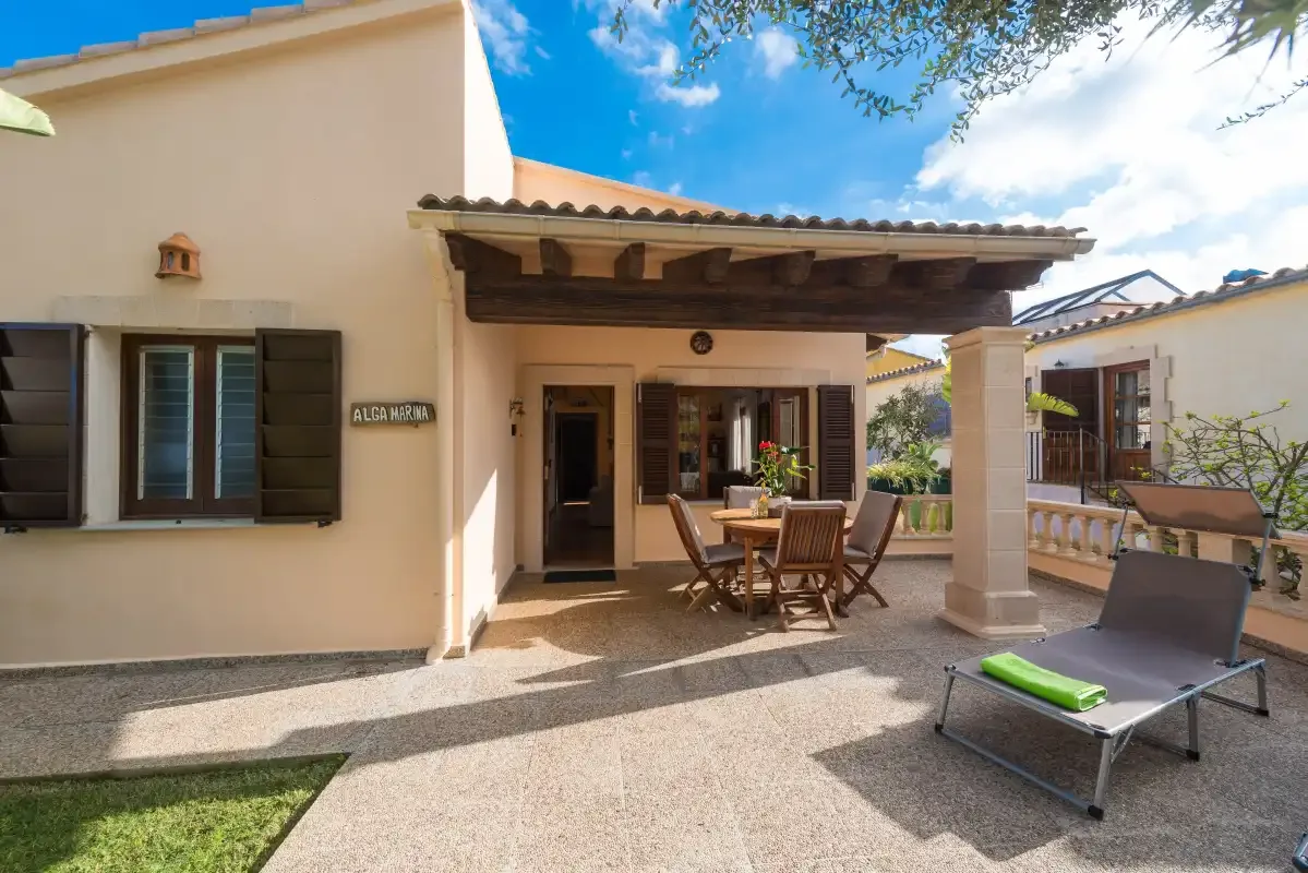 A house patio with a covered dining area and lounge chair.