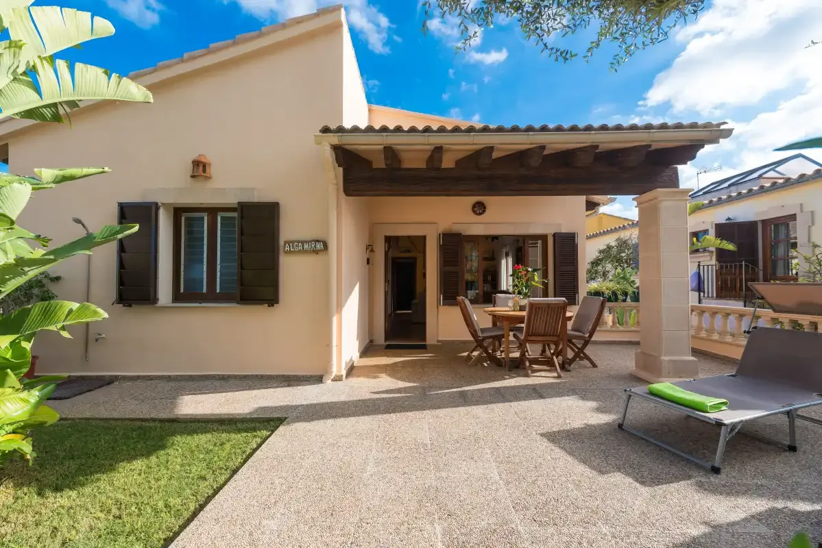 A house patio with a covered seating area and outdoor table.