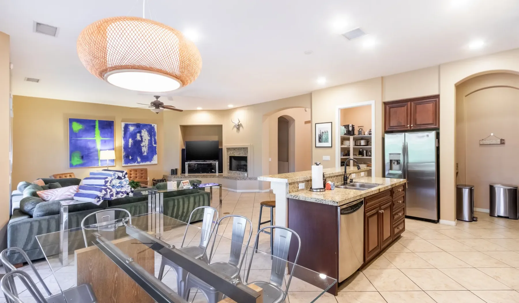 An open-plan kitchen and dining area with a living room visible beyond.