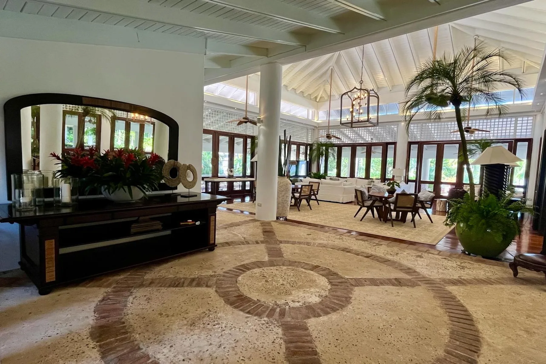 A spacious dining room with tables beneath a high, bright ceiling.