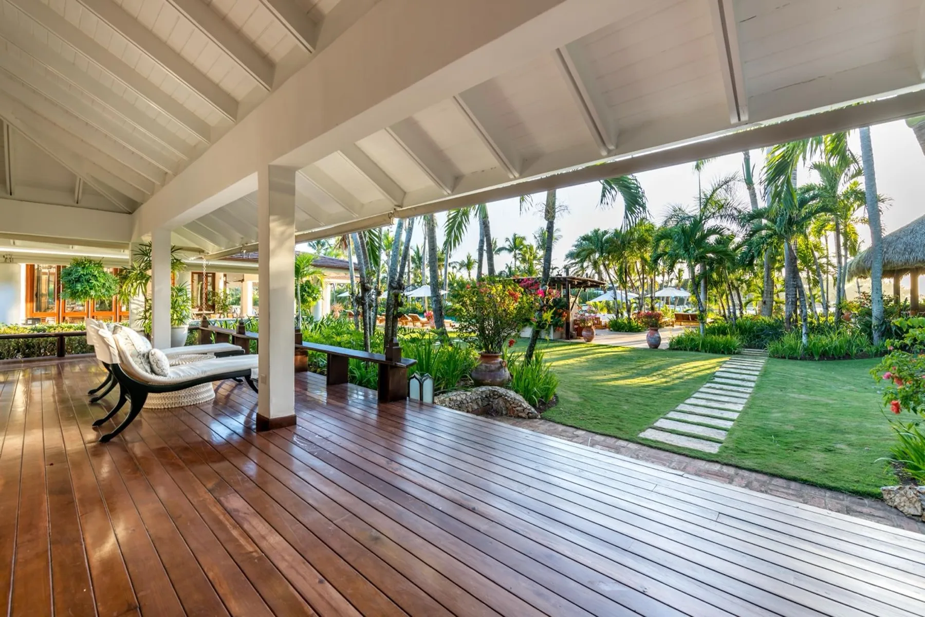 A covered patio opens onto a landscaped garden with a stepping-stone path.