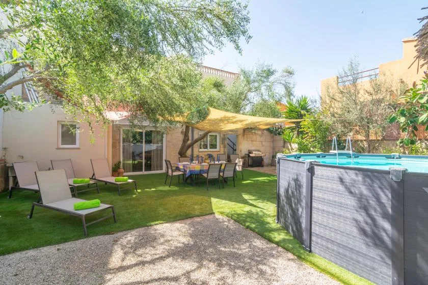 A landscaped courtyard with outdoor seating, trees, and a raised pool.