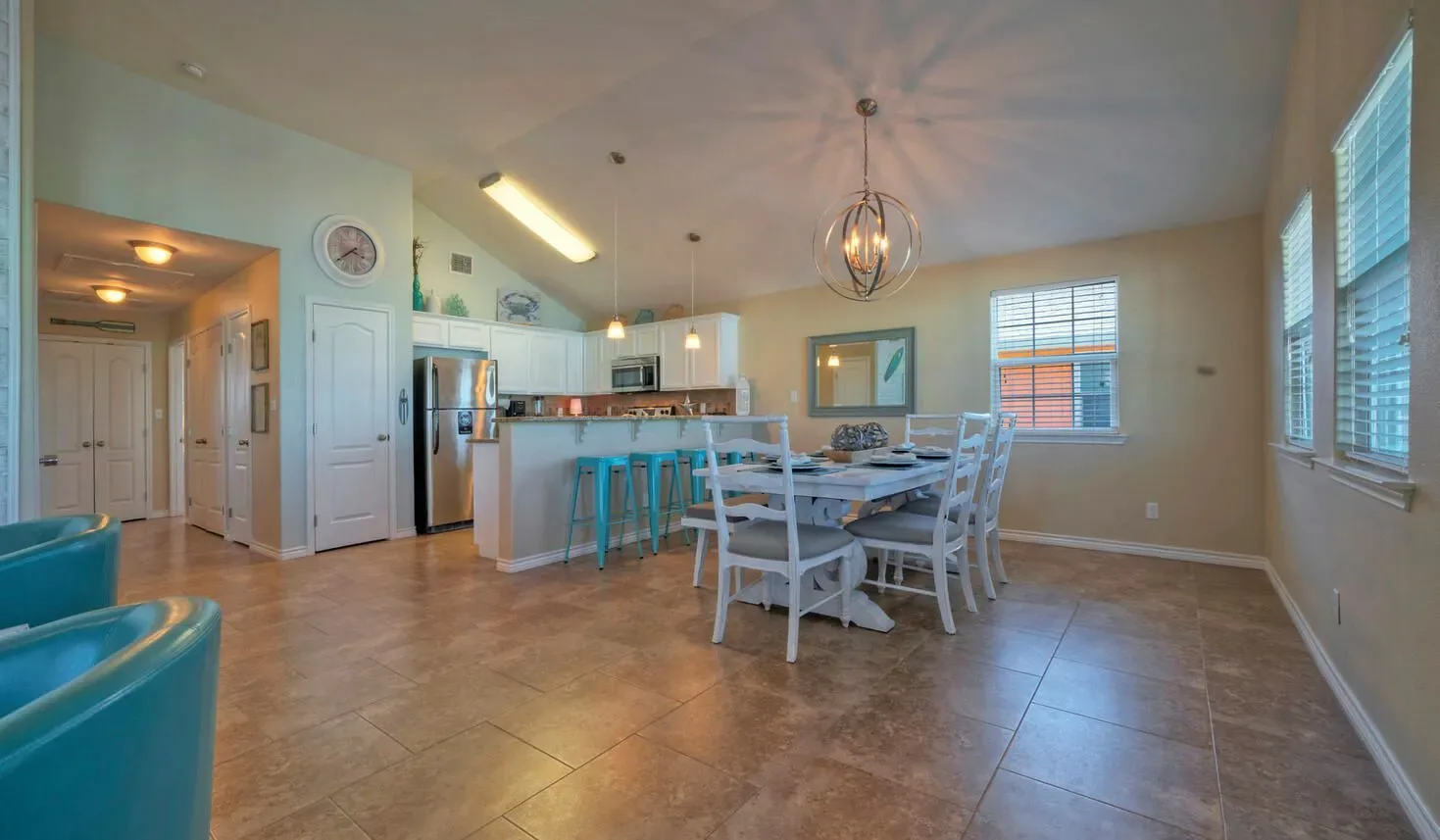 An open kitchen and dining area with a table and chairs.