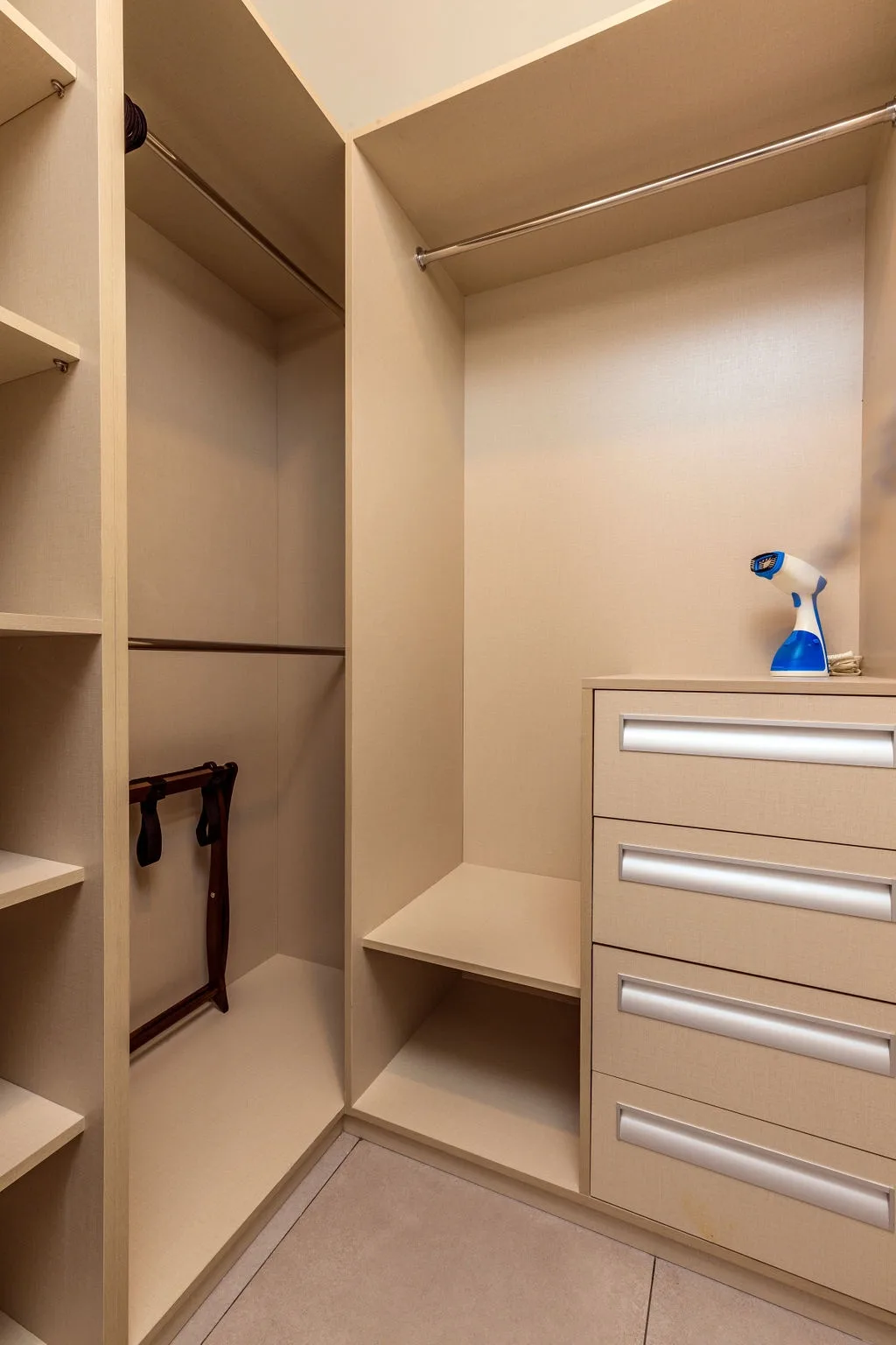 You'll find plenty of space for all your belongings in this walk-in closet, with thoughtful shelving, hanging rods, and drawer storage to keep everything organized during your stay.