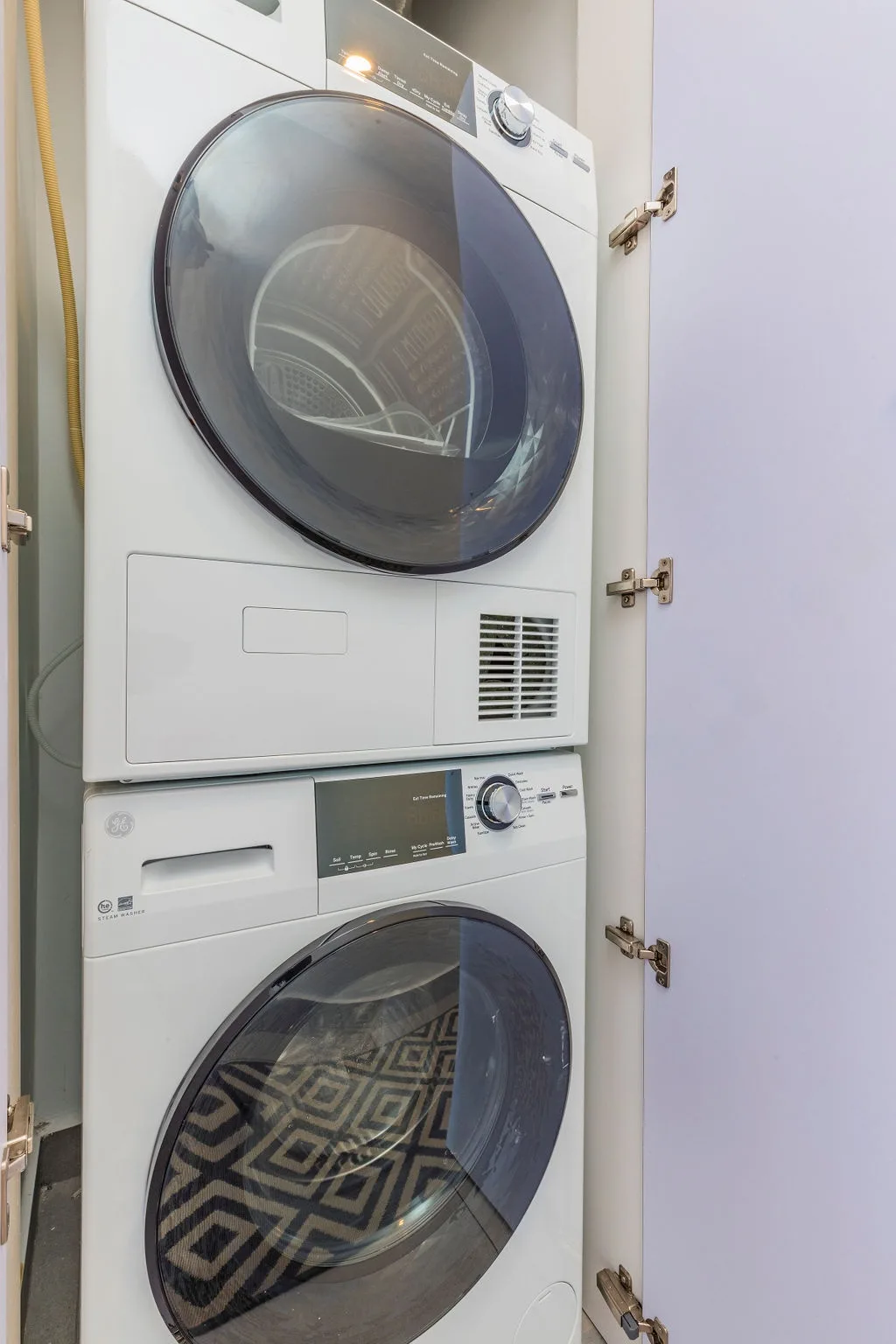 Keep your wardrobe fresh during your stay with the in-unit washer and dryer, conveniently stacked to save space while providing full laundry capabilities.