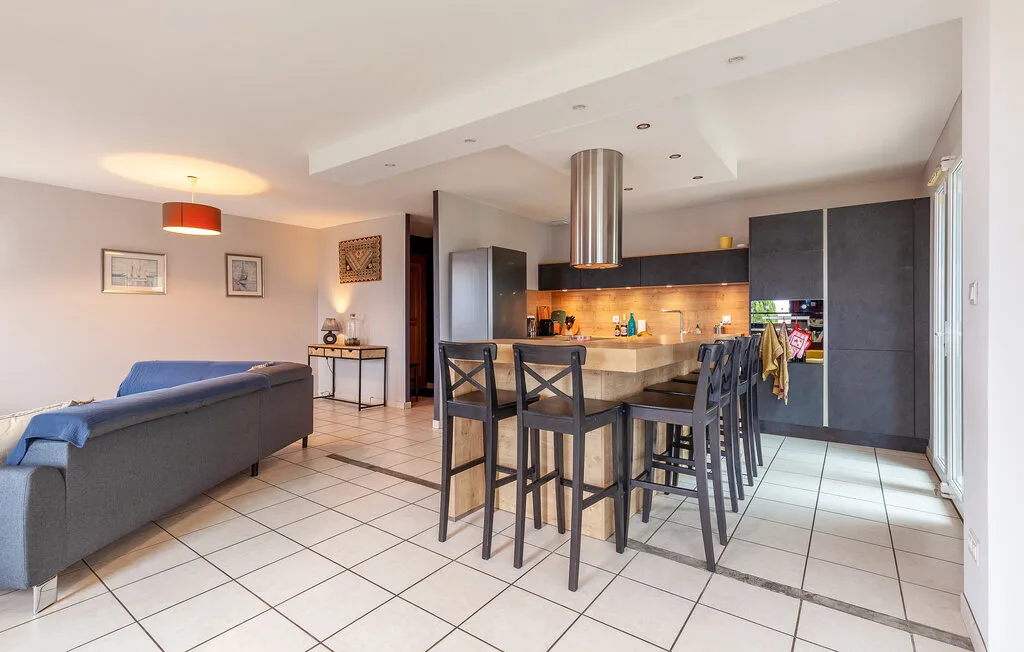An open-plan living and kitchen area with a dining counter and seating.