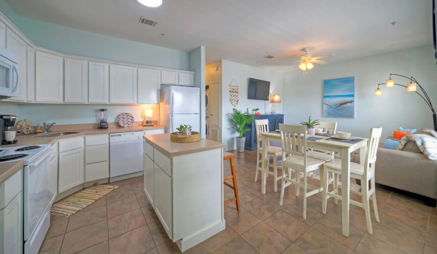 An open-plan kitchen and dining area with a table beside the kitchen island.