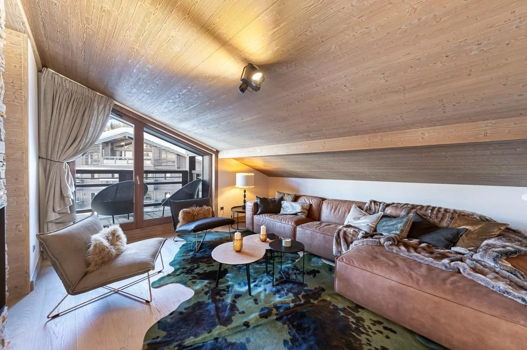 A spacious living room with a sectional seating area and large windows.