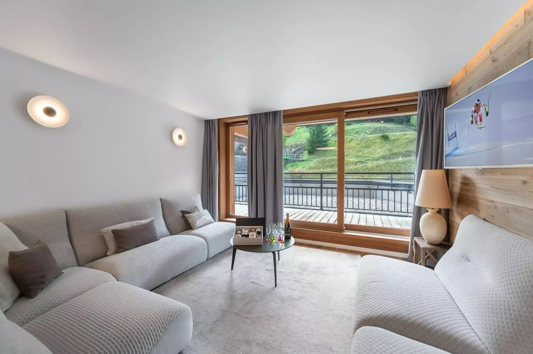 A bright living room with seating around a small coffee table.