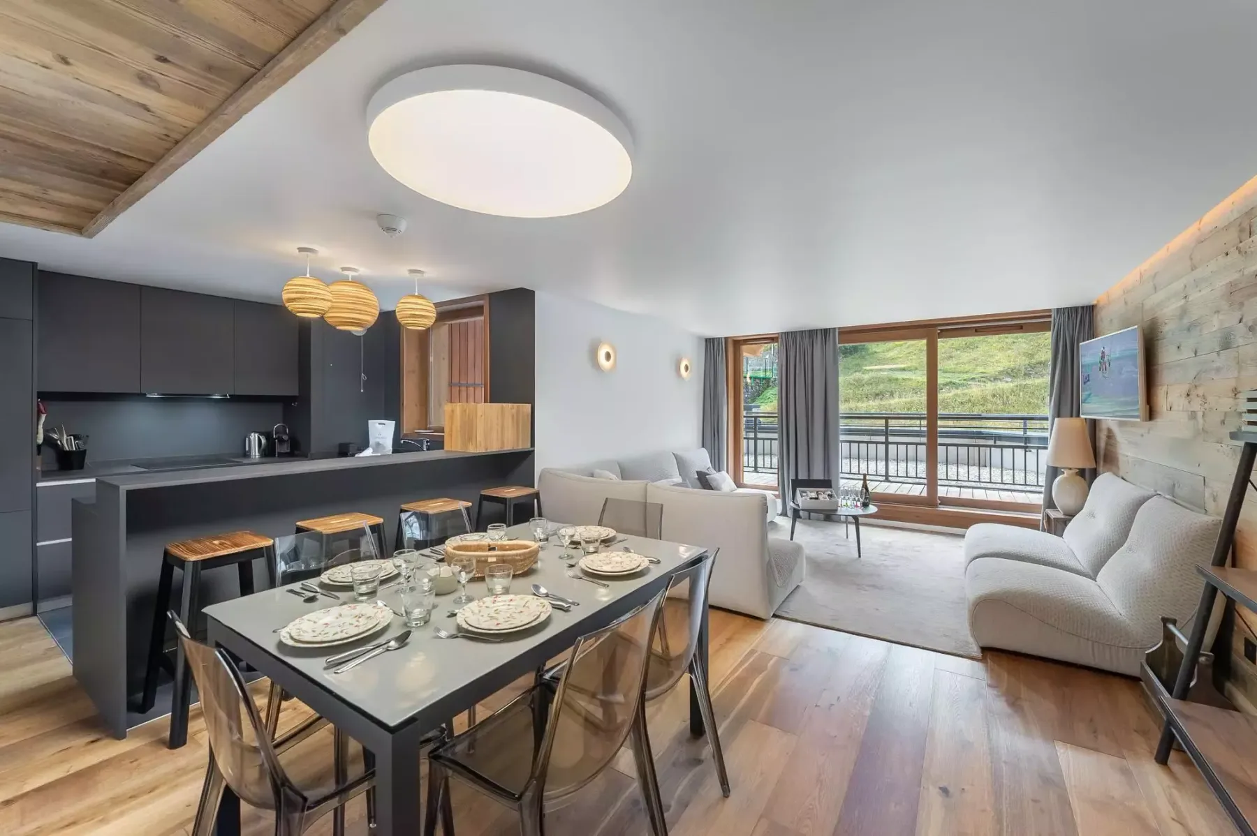 An open-plan living and dining area with a set dining table and seating.
