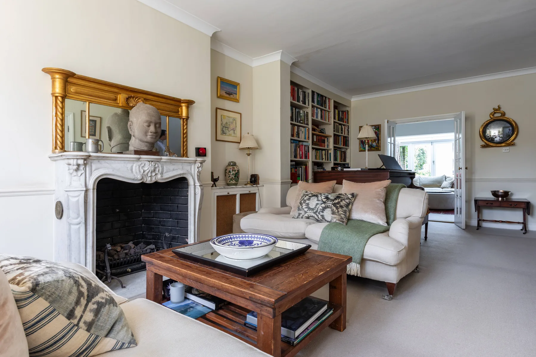 Living room with a fireplace, seating, and bookshelves.
