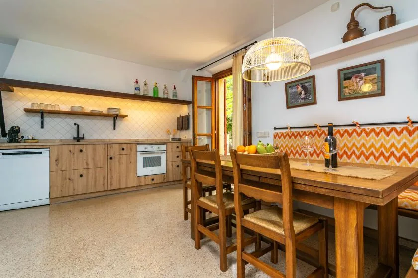 A kitchen and dining area with a wooden table and chairs.