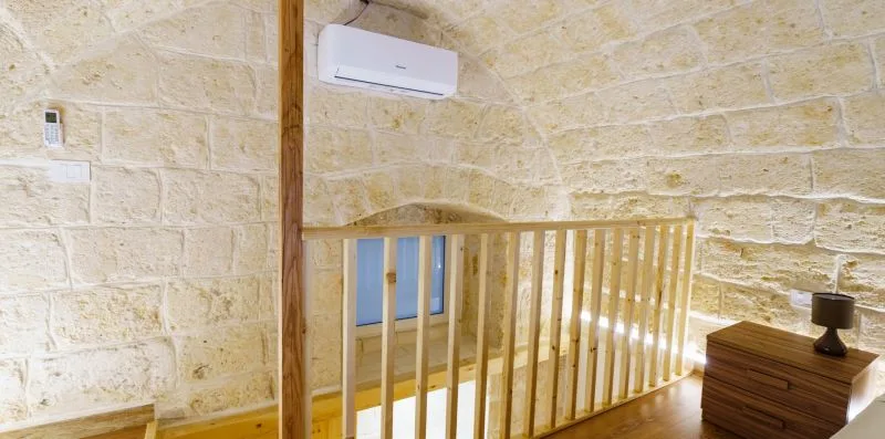 A stone-walled interior with a wooden railing and a small chest.