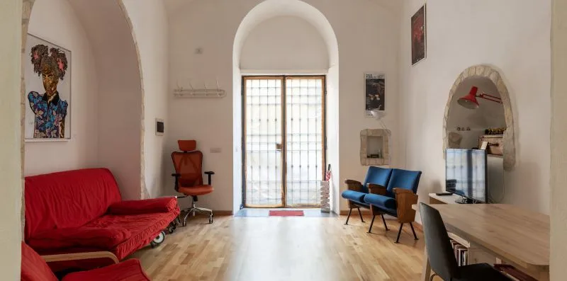 A bright living room with seating around a large glazed doorway.