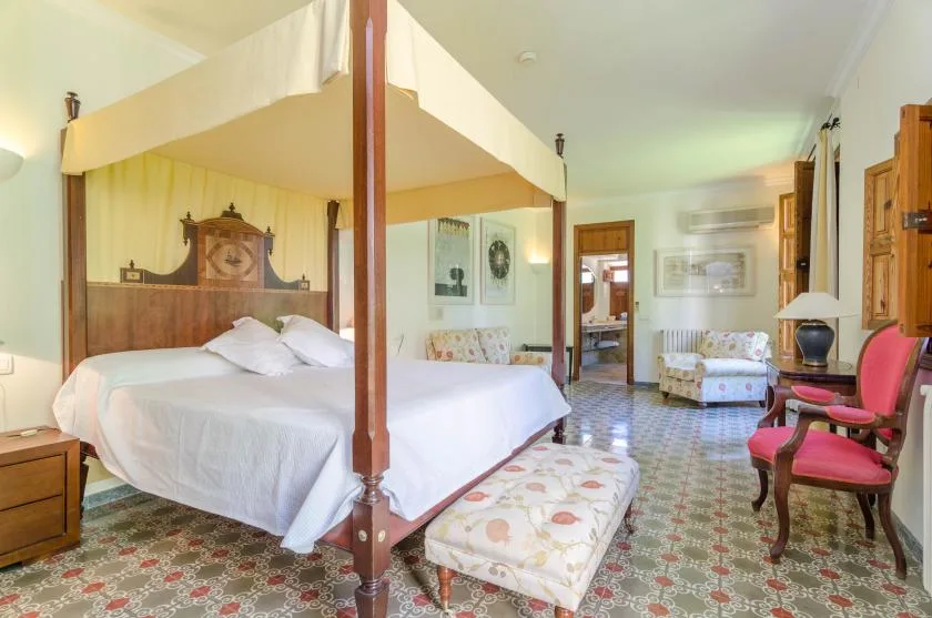 A bedroom with a canopy bed and a patterned floor.
