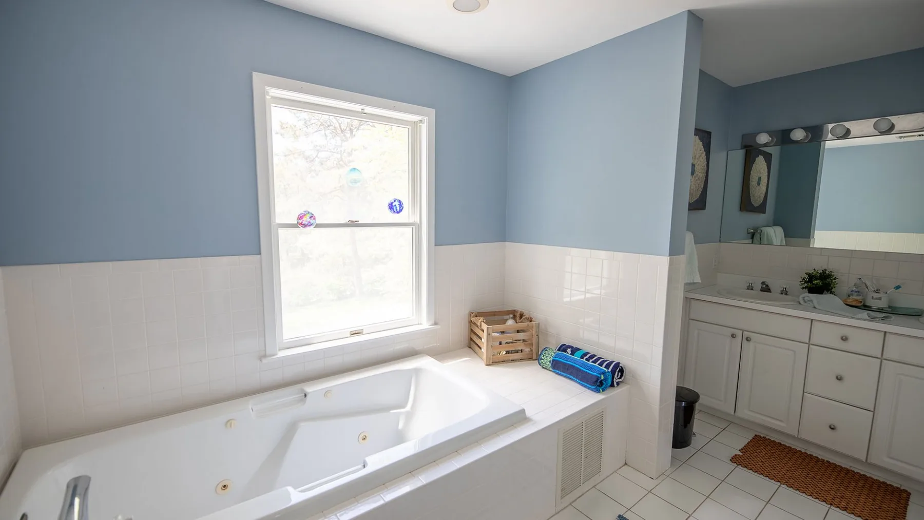A bathroom with a built-in bathtub and a vanity with a mirror.
