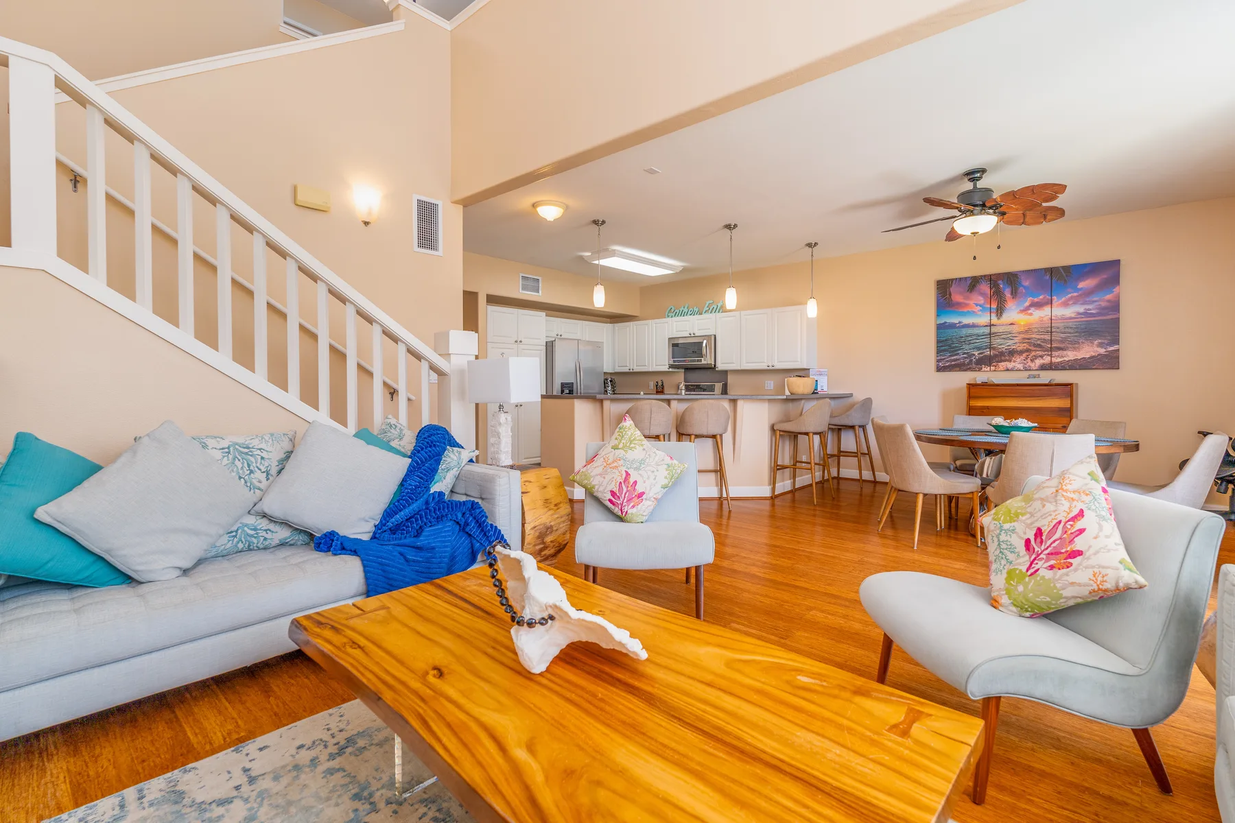 An open-plan living and dining area with a kitchen, seating, and a wooden coffee table.