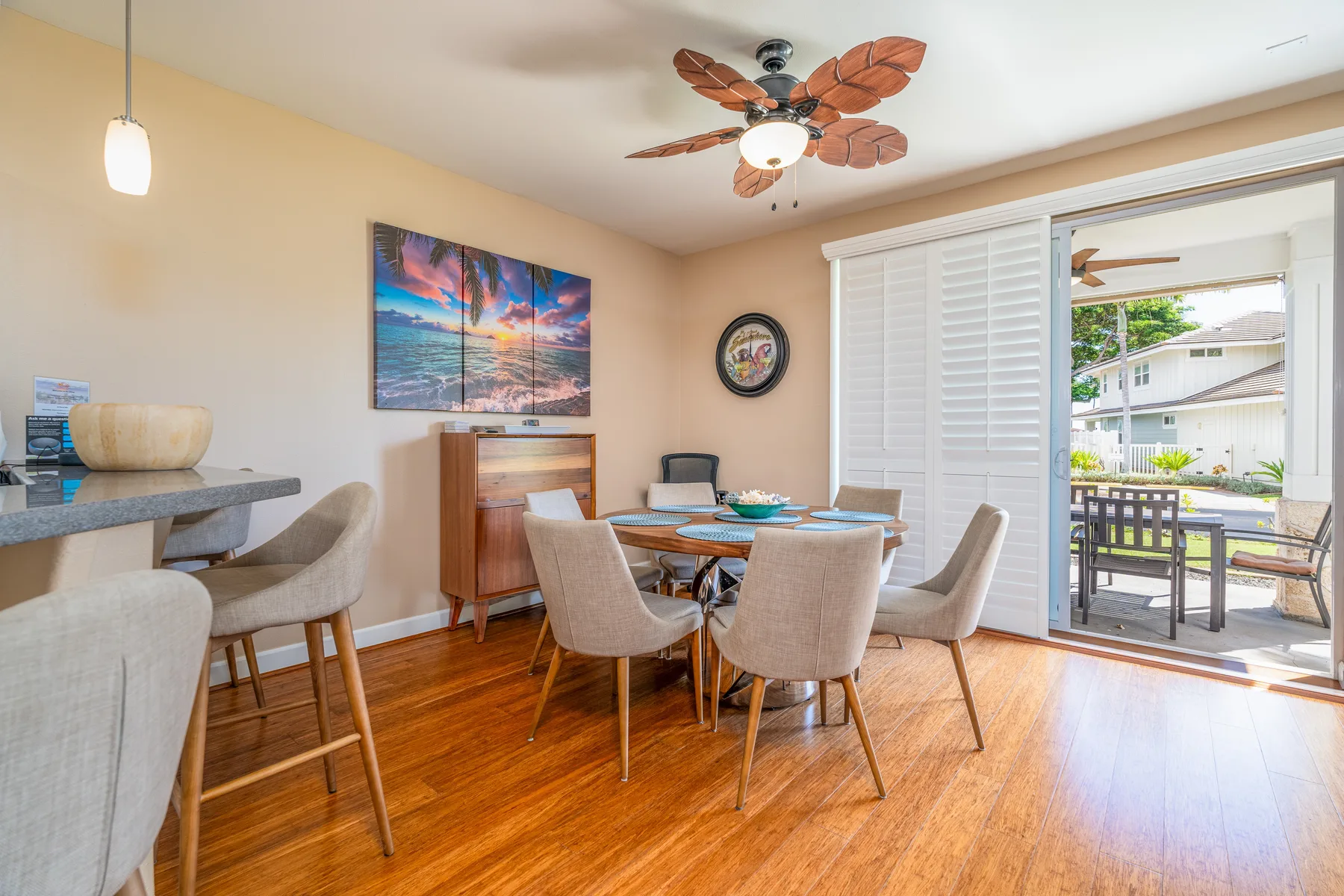 A dining area with a table and chairs beside an open patio doorway.