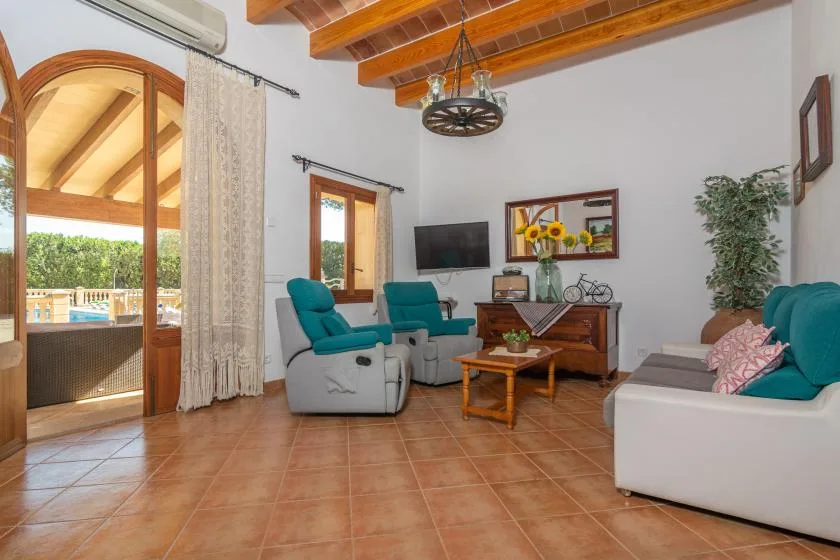 A living room with seating, a coffee table, and a television.