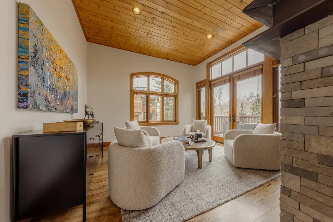 A bright living room with seating arranged around a low coffee table.