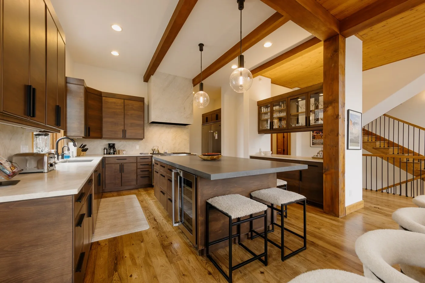 A spacious kitchen with a central island and warm wood cabinetry.