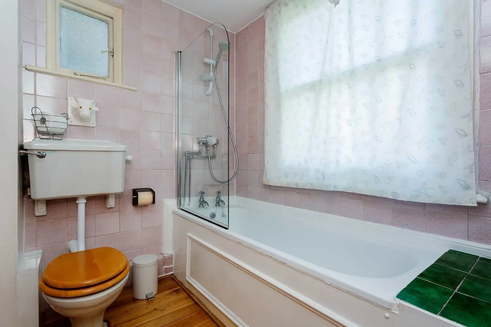 A tiled bathroom with a bathtub, shower, and sink.