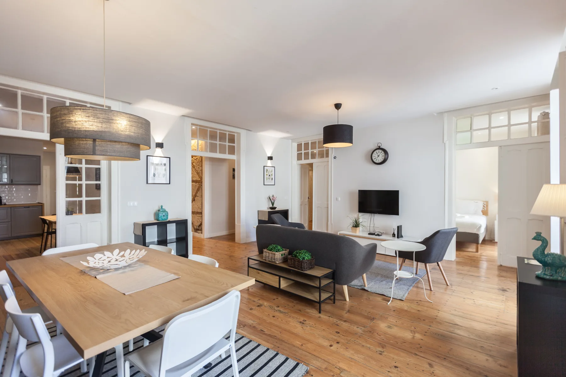 A bright open-plan living and dining area with a television and seating.