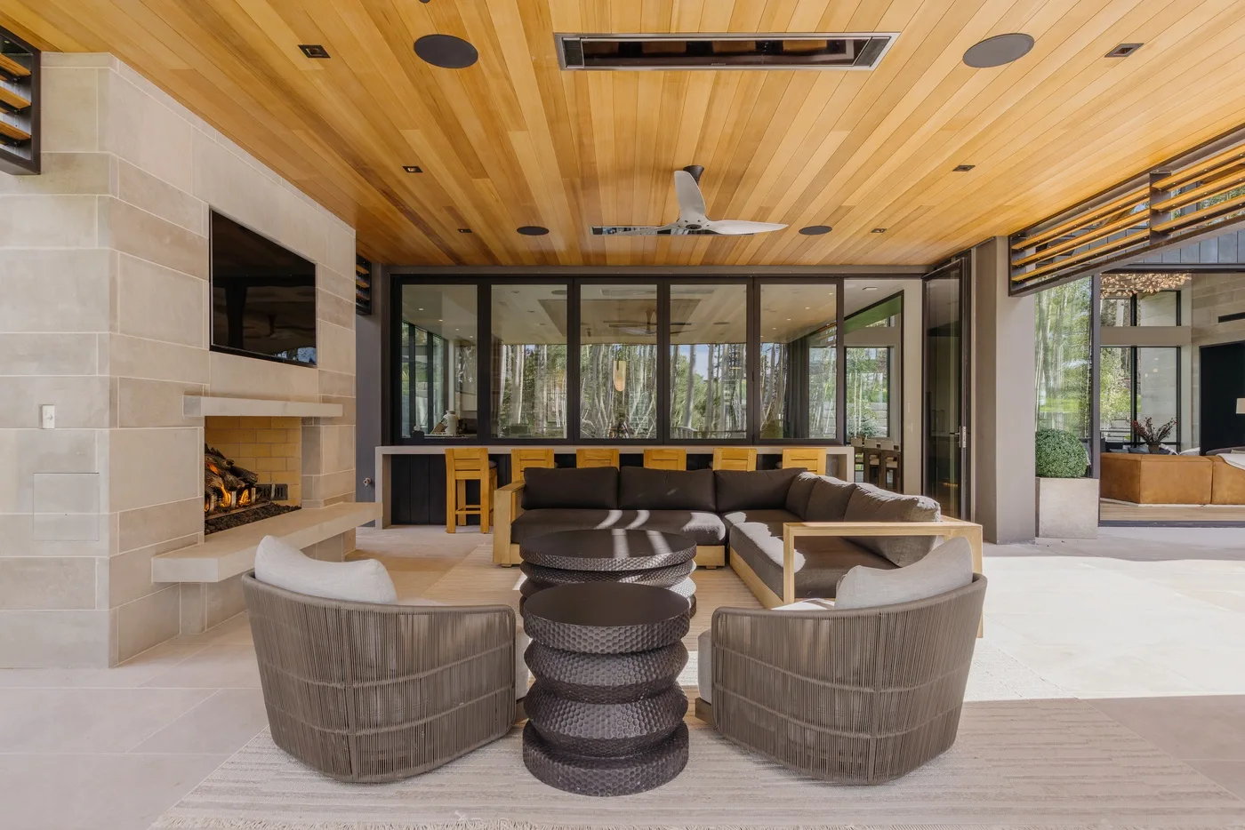 A modern living room with a fireplace and seating around a low table.