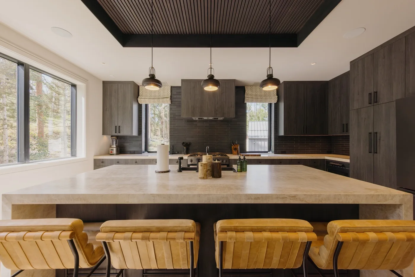 A modern kitchen with a large island and bar seating.